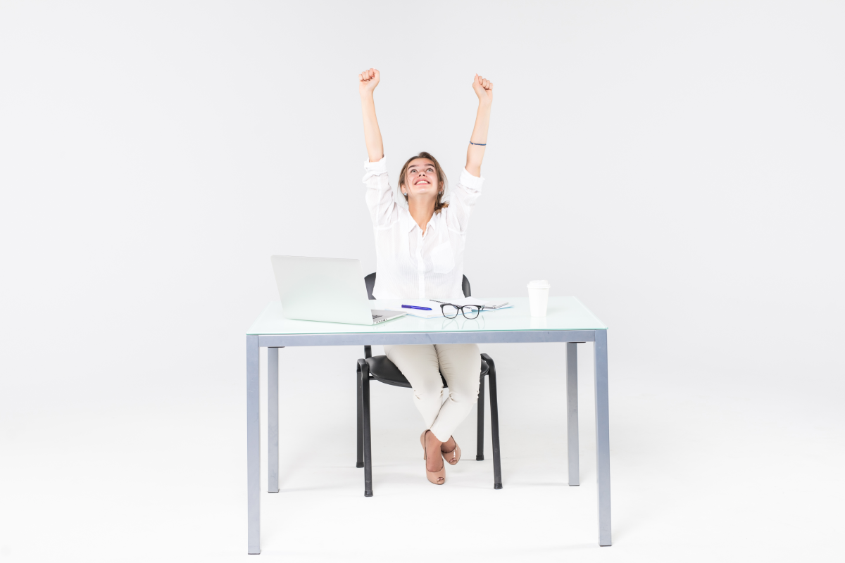 celebrating-businesswoman-desk-with-laptop_1200x800.webp